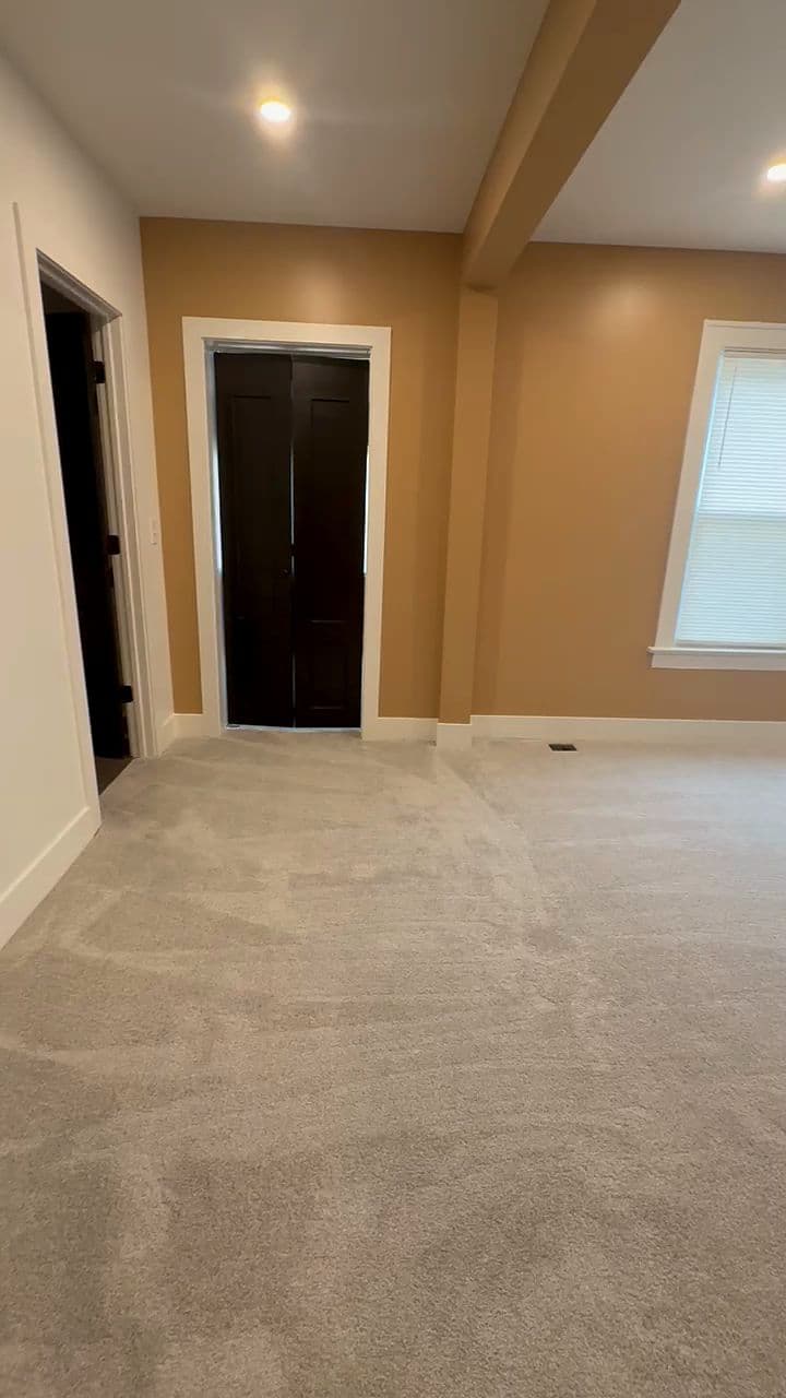 Empty new bedroom with fresh vacuum lines in the carpet